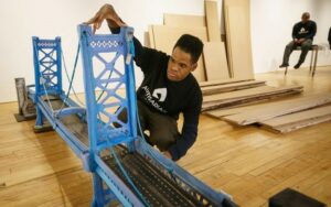 Kambel Smith, who has autism, is shown making final adjustments to his sculpture of the Benjamin Franklin Bridge prior to his art show at the Fleisher/Ollman Gallery in Philadelphia. (Jessica Griffin/The Philadelphia Inquirer/TNS)
